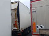 two trucks that are parked next to each other