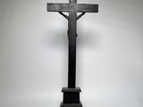 an image of a cross on a pedestal against a white background