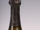 an old bottle of wine sitting on top of a table