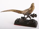 bronze statue of a pheasant perched on a branch of a tree