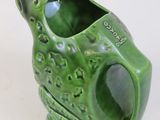 a green frog shaped vase with a hole in it