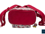 a small red bag with a red handle on it