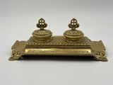 a brass inkwell with two inkwells on top of it