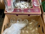 a box full of glassware and other items on the floor