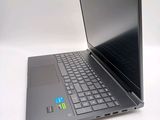a laptop computer sitting on a table with a keyboard