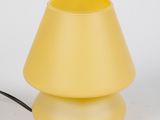 yellow table lamp with a black cord on a white background