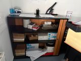 a desk with a bookcase and a computer on it