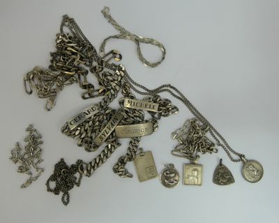 a lot of silver jewelry on a white surface