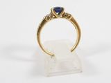 a gold ring with a blue sapphire and diamonds