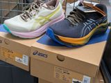 two pairs of shoes sitting on a box in a store
