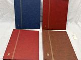 three red, blue and brown binders on a white background