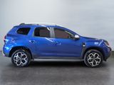 the blue suv is parked in a room with a gray wall