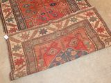 an image of a rug on the floor with a cat laying on top of it