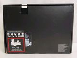 a black box that is open on a white surface