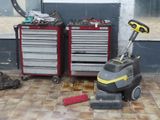 a machine that is sitting on the floor next to a tool box