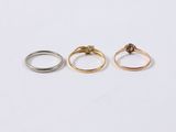 three gold and silver rings on a white background