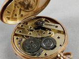 an image of a gold pocket watch with gears inside of it