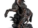 statue of a man riding a horse on a stone base