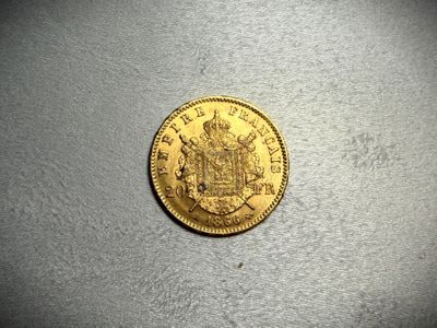 a close up of a gold coin on a white surface
