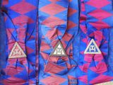 several different colored ties in a box with fringes on them