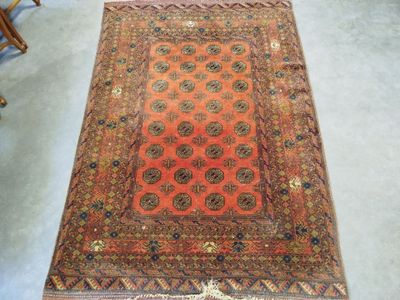 an old rug is on the floor with a chair in the background