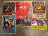 several movie posters on the floor in a room