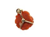 an image of a red coral pendant with a gold cross