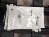 a plastic bag on the back of a black suitcase