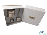 a white box with a set of creams inside of it