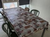 a table and chairs in a room with a window in the background