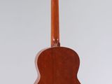 an acoustic guitar hanging from the ceiling