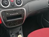 the dashboard of a car with a bottle of beer in the front seat