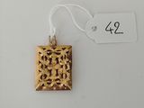 an image of a gold pendant on a white background