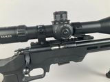 the scope of a rifle with a red dot on top of it