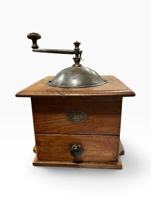 an old coffee grinder on a white background with a white background