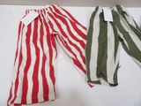 two pairs of red and white striped pants on a white surface