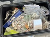a trash can filled with assorted items on the floor