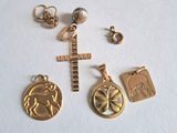 a lot of gold charms on a white surface