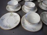 a lot of cups and saucers on the table