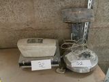 a scale and a blender sitting on a shelf