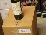 a bottle of wine sitting on top of a cardboard box