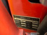 a close up of a red motorcycle with a number plate on it
