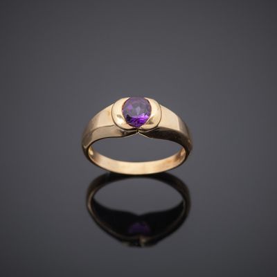 a gold ring with an amethe stone in the center
