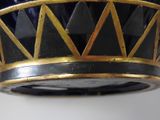 a black and gold vase with a crown on top of it