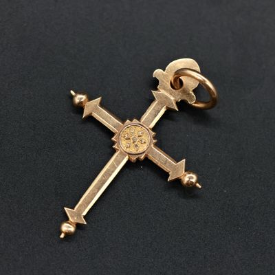 a close up of a cross on a black surface