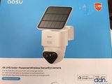 a box with a solar powered security camera inside of it