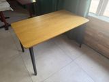 a table with a wooden top and metal legs
