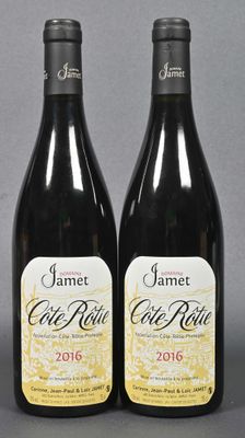 two bottles of wine sitting next to each other on a table