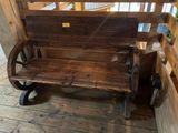 a wooden bench with a wheel on the back of it