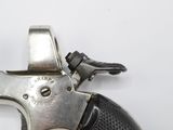 a gun that is sitting on a white surface